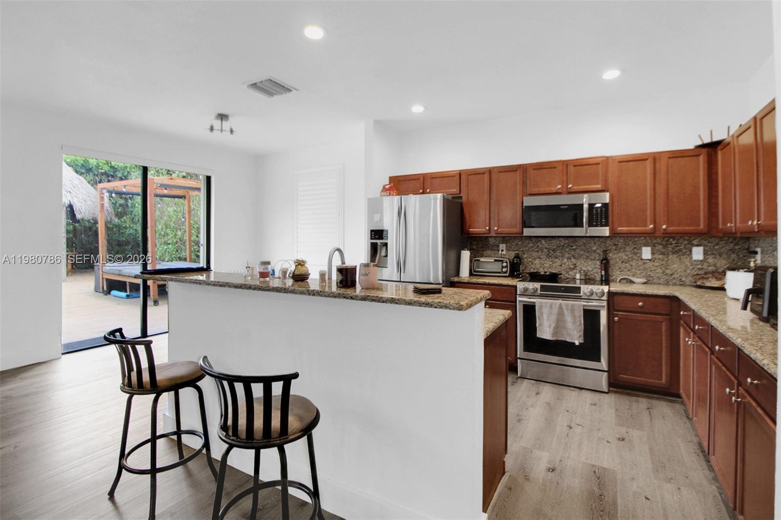 17343 Southwest 155th Court Miami, FL 33187 - Photo 15 of 40 SIT AT THE BAR OF YOUR NEW KITCHEN!