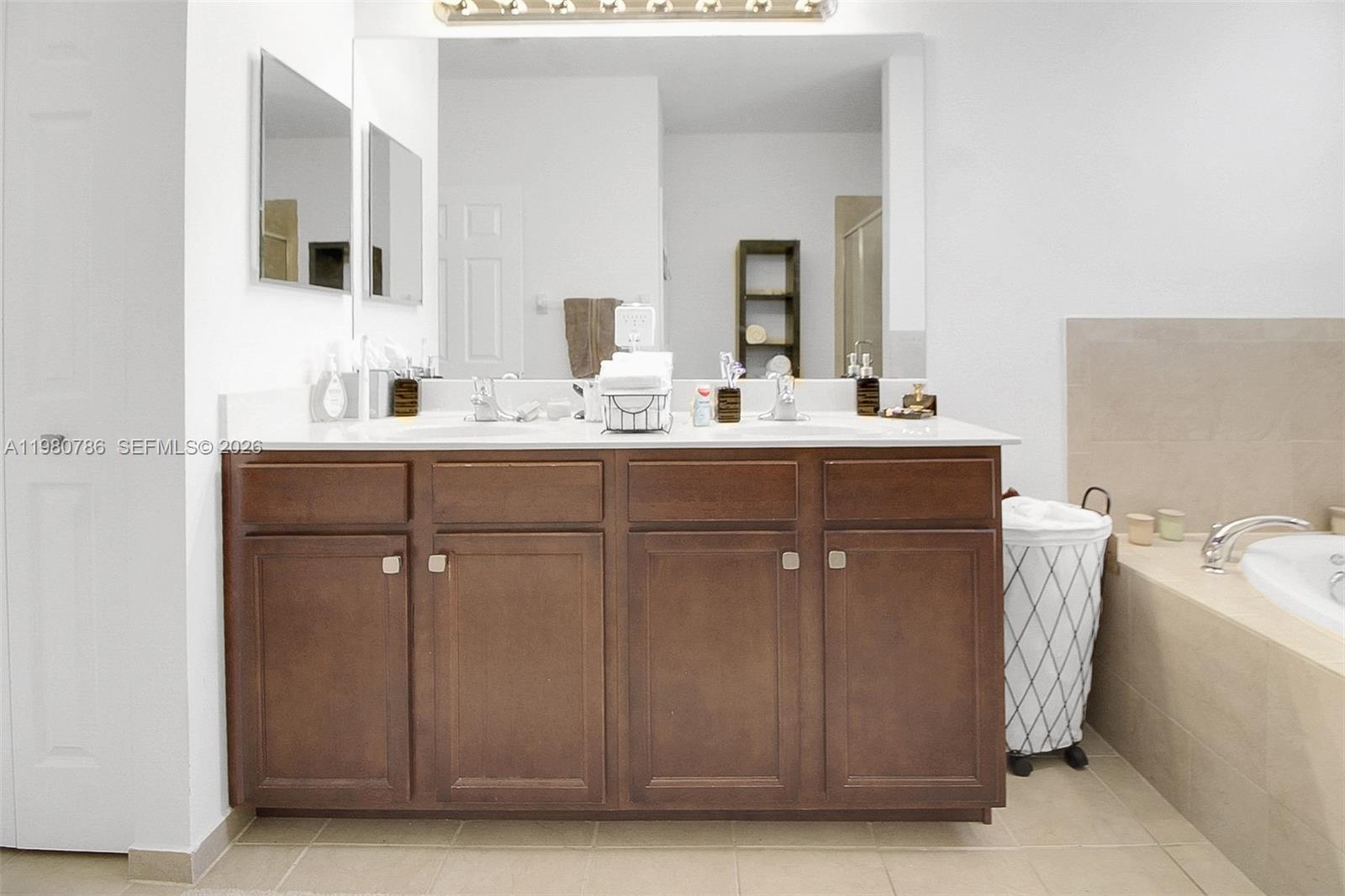 17343 Southwest 155th Court Miami, FL 33187 - Photo 28 of 40 OVERSIZED MIRROR AND VANITY IN YOUR MASTER BATHROOM!