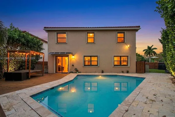 a view of a house with swimming pool and sitting area
