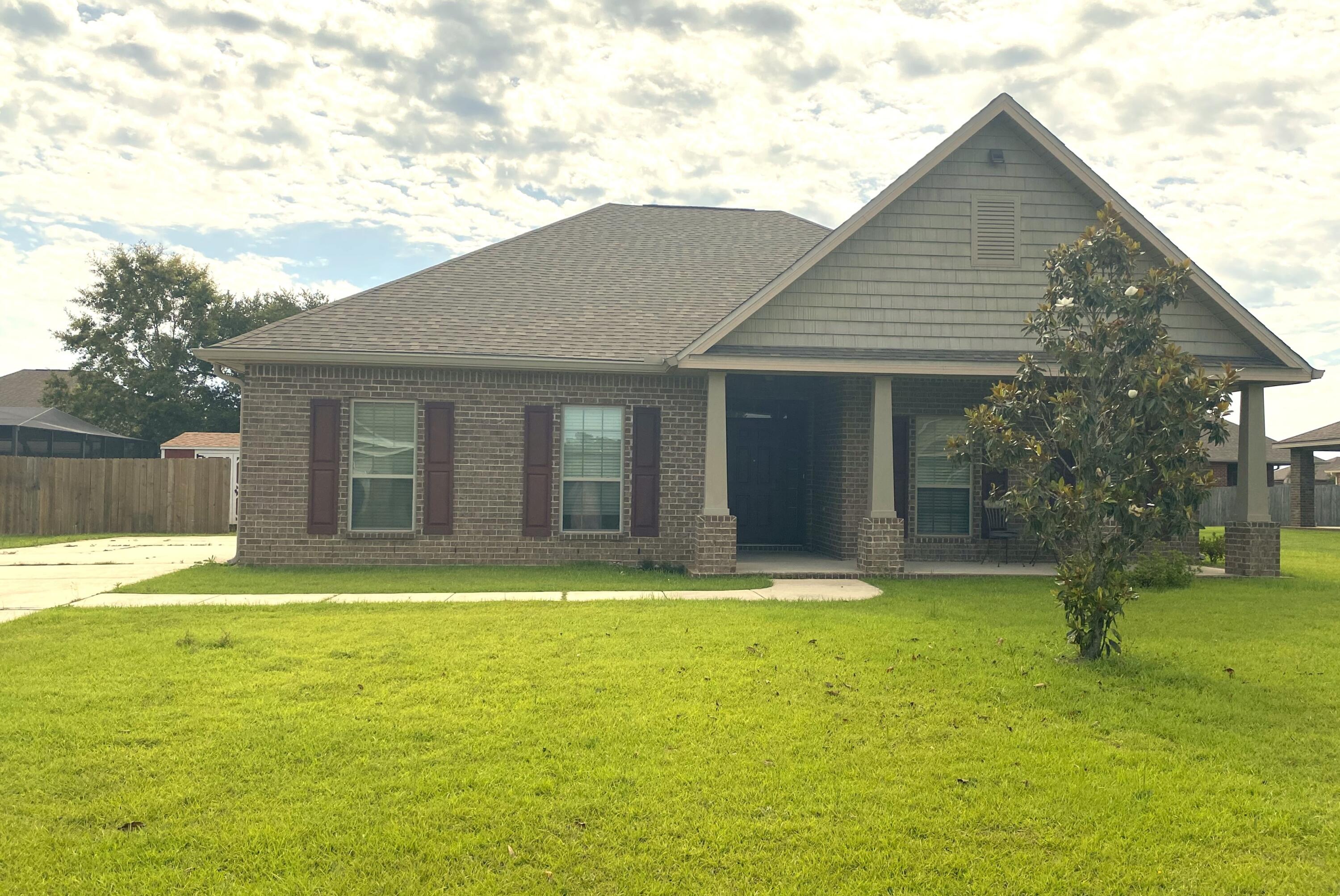 5870 Pescara Drive Pace, FL 32571 - Photo 1 of 31 a swimming pool with outdoor seating and yard
