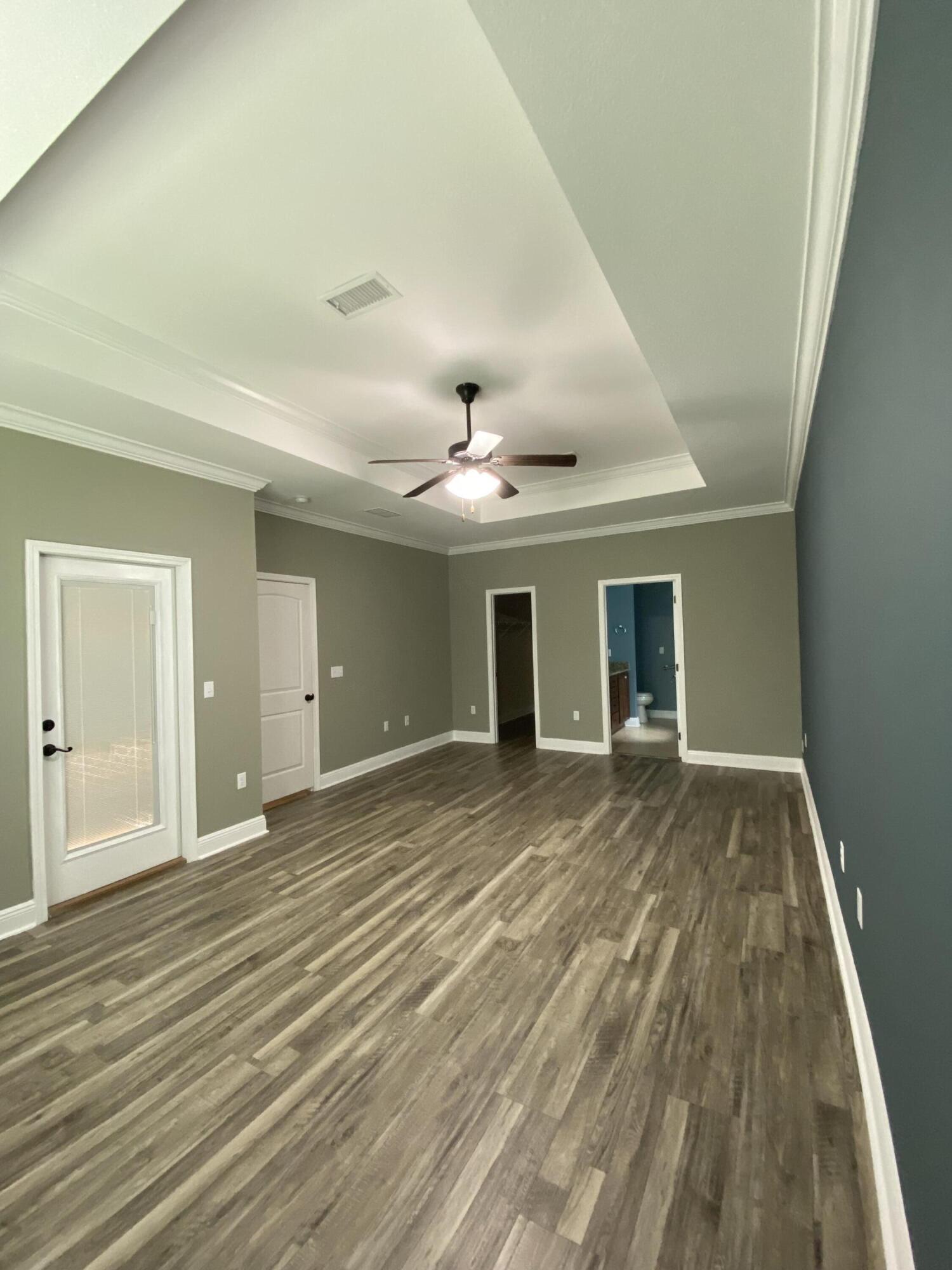 5870 Pescara Drive Pace, FL 32571 - Photo 18 of 31 en empty room with wooden floor and ceiling fan