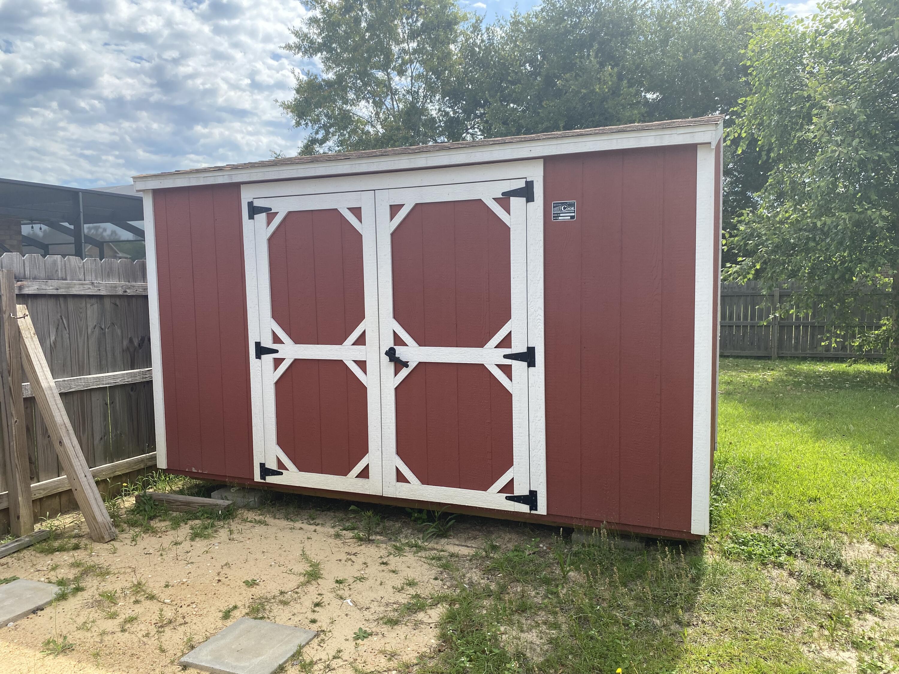 5870 Pescara Drive Pace, FL 32571 - Photo 29 of 31 a backyard of a house with garden