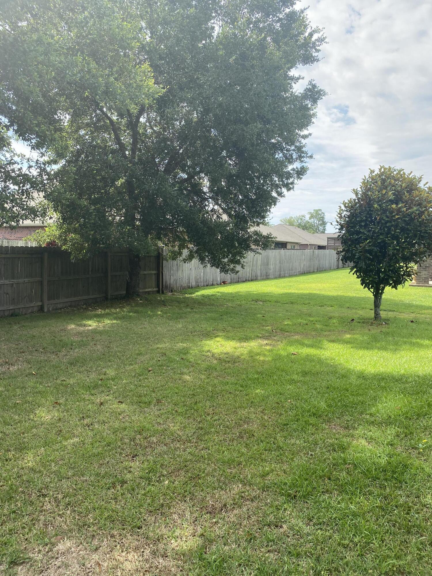 5870 Pescara Drive Pace, FL 32571 - Photo 31 of 31 a view of an outdoor space and a yard