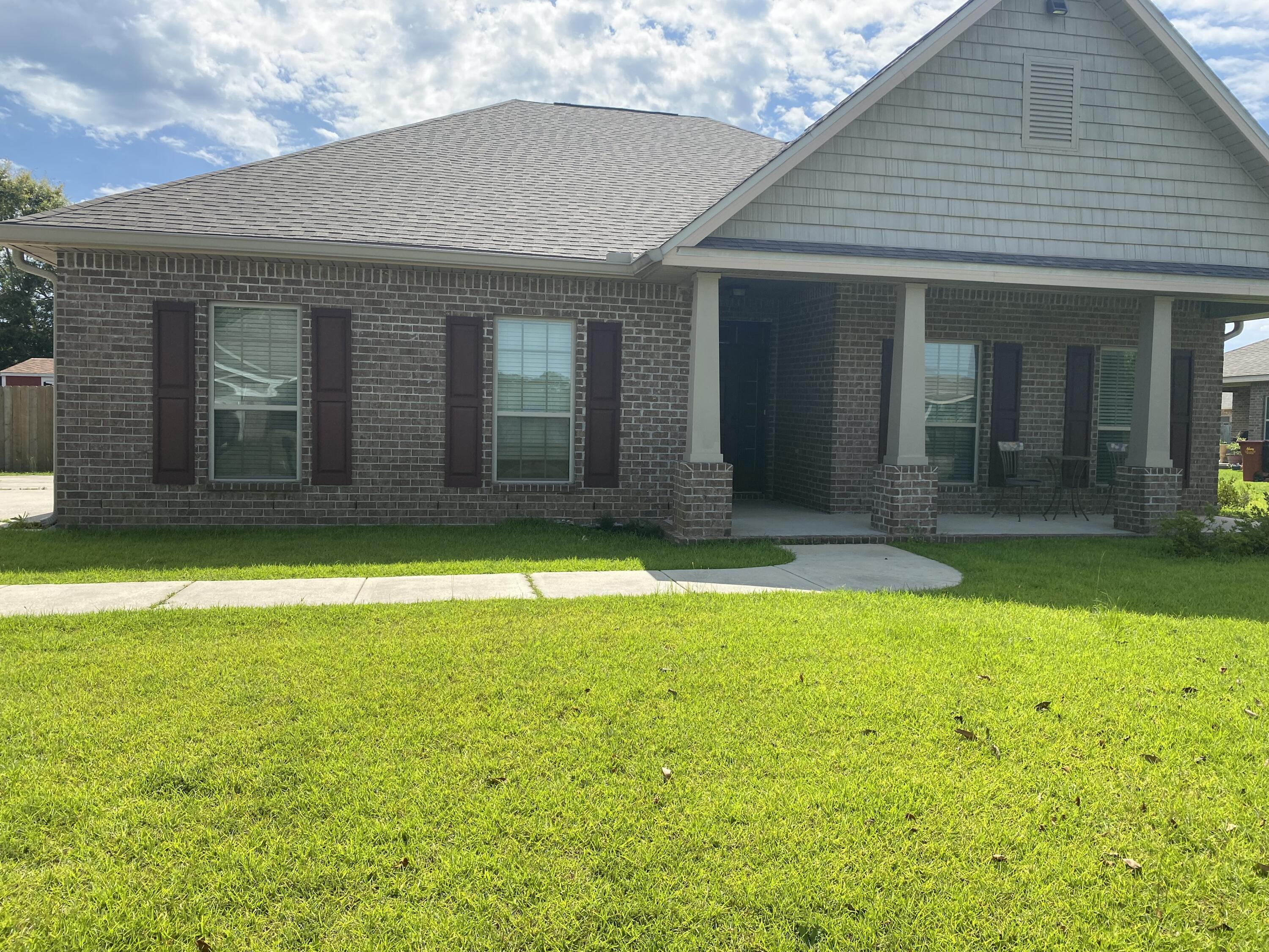 5870 Pescara Drive Pace, FL 32571 - Photo 4 of 31 a front view of a house with a yard