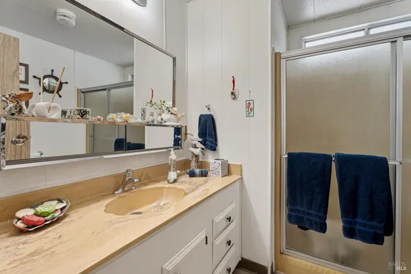 a bathroom with a sink vanity and mirror