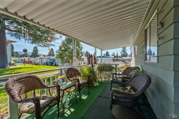 an outdoor sitting area with furniture and garden view