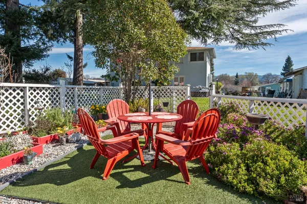 a view of a chairs and table in backyard