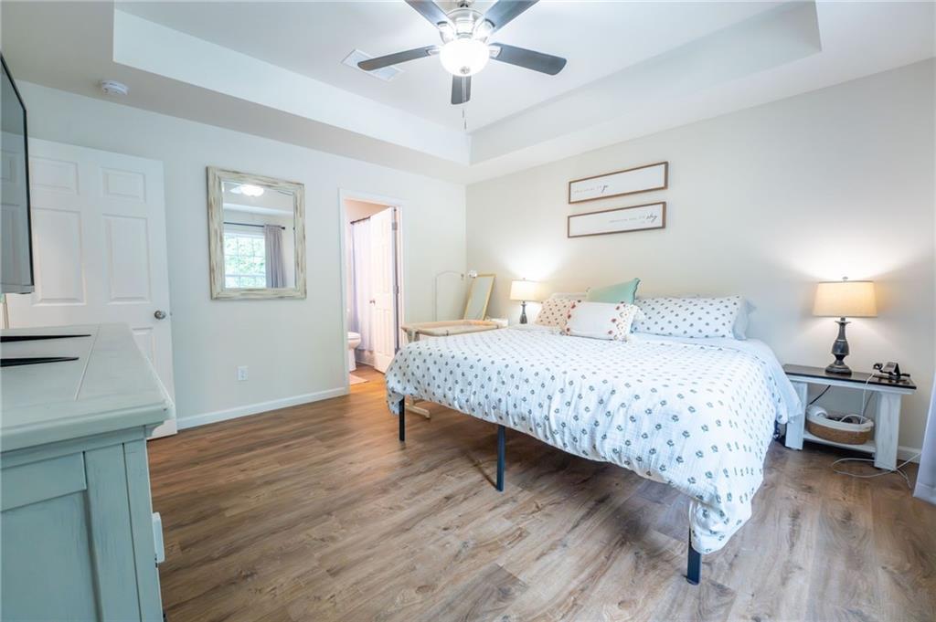 118 Wash Rider Road Dahlonega, GA 30533 - Photo 22 of 37 a bedroom with a bed and a chandelier
