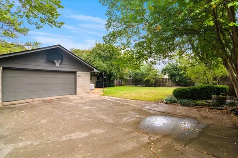 a view of a house with a yard and garage