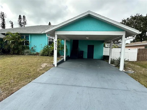 a front view of a house with plants