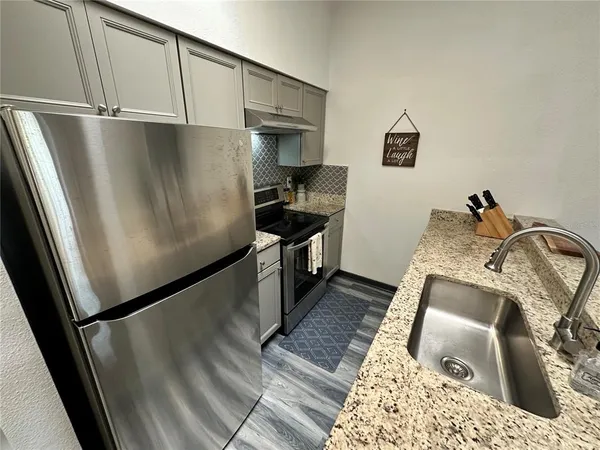 a kitchen with a sink and a refrigerator
