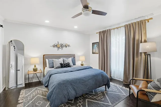 a bedroom with a bed and a mirror