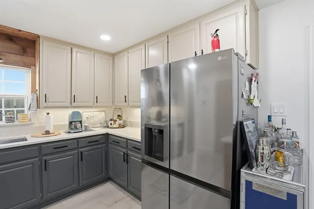 a kitchen with a sink and refrigerator