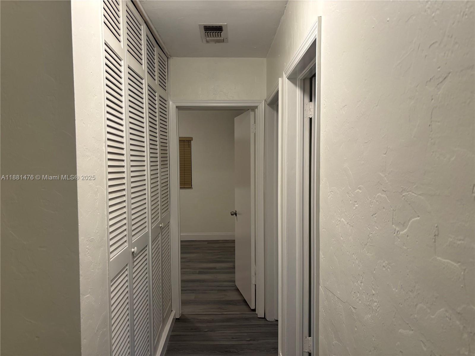 13041 Northwest 17th Court Miami, FL 33167 - Photo 11 of 23 a view of a hallway with a wooden door