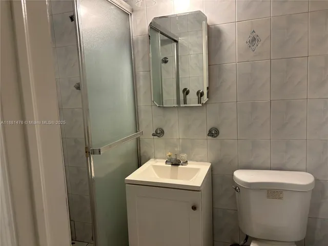 a bathroom with a sink toilet and mirror