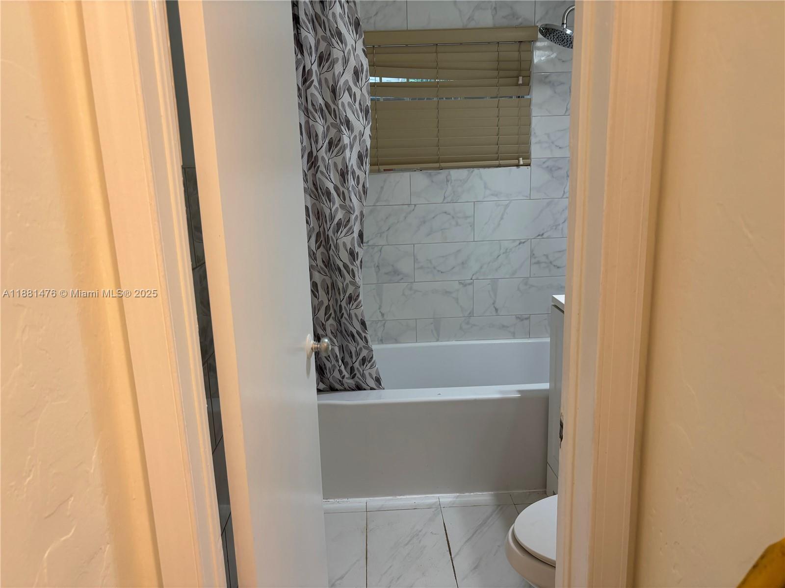 13041 Northwest 17th Court Miami, FL 33167 - Photo 16 of 23 a bathroom with a toilet and a bathtub