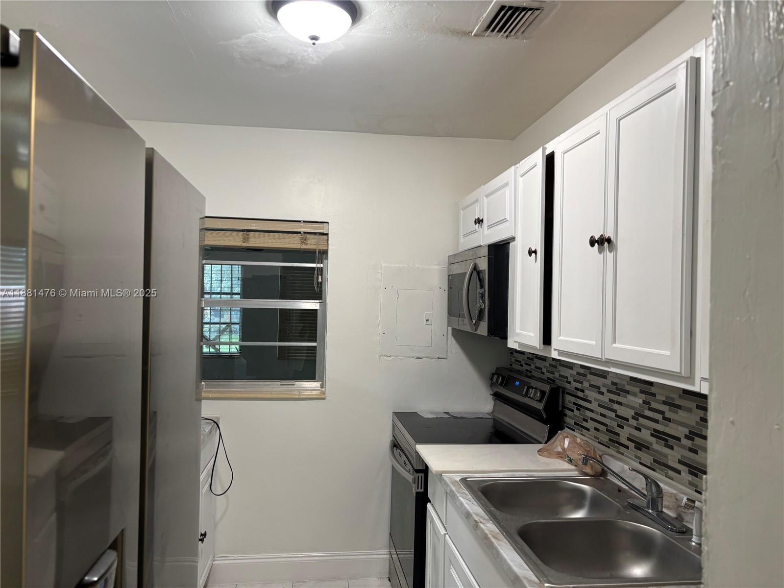 13041 Northwest 17th Court Miami, FL 33167 - Photo 18 of 23 a bathroom with a sink a vanity and a mirror