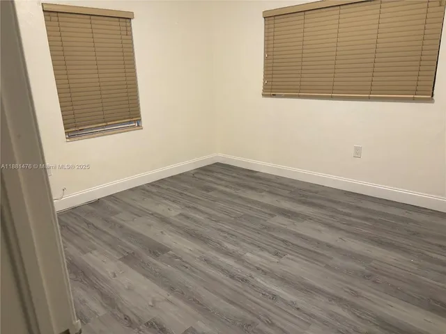 an empty room with wooden floor