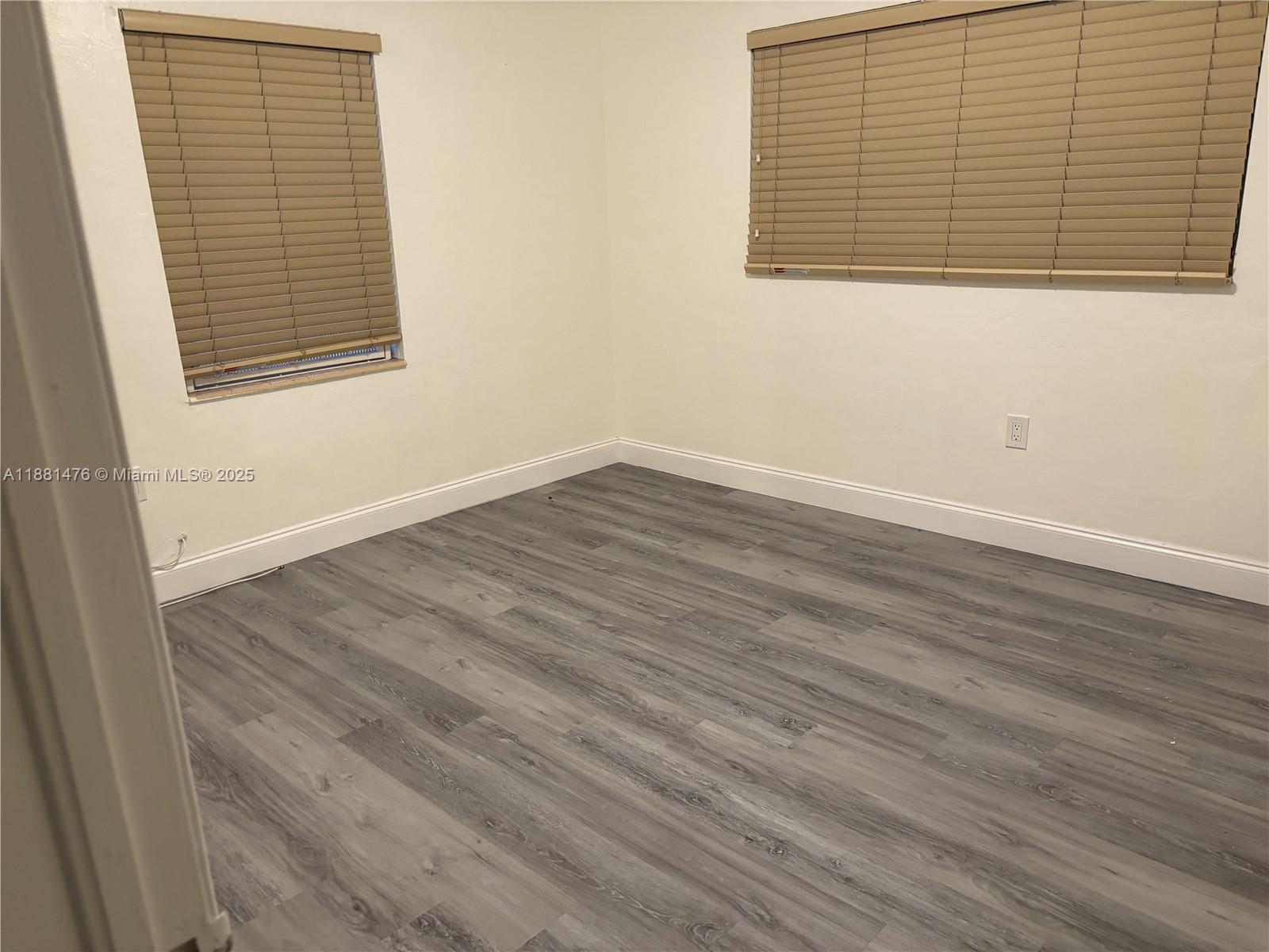 13041 Northwest 17th Court Miami, FL 33167 - Photo 22 of 23 an empty room with wooden floor