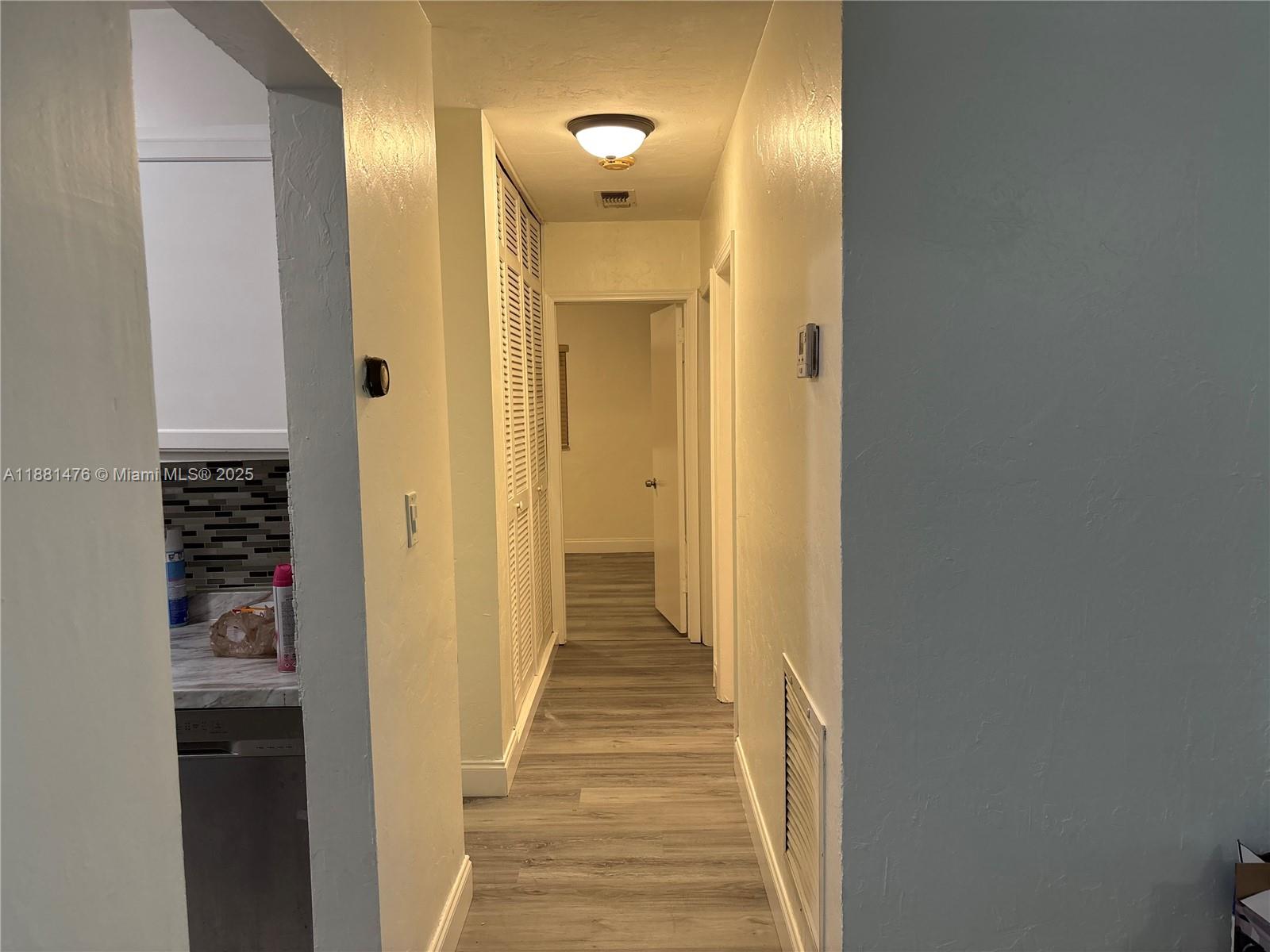 13041 Northwest 17th Court Miami, FL 33167 - Photo 4 of 23 a view of a hallway with wooden floor