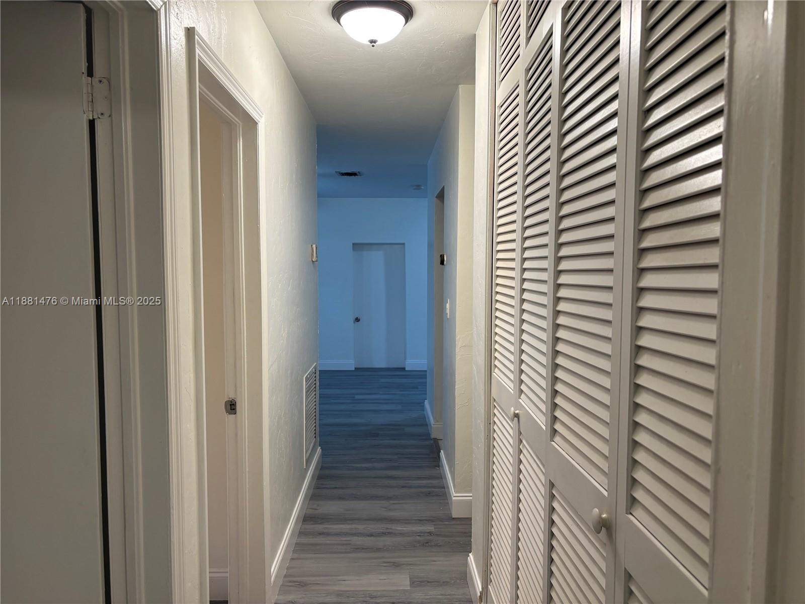 13041 Northwest 17th Court Miami, FL 33167 - Photo 5 of 23 a view of a hallway with wooden floor