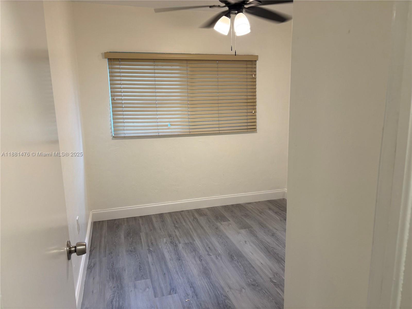 13041 Northwest 17th Court Miami, FL 33167 - Photo 6 of 23 an empty room with a window