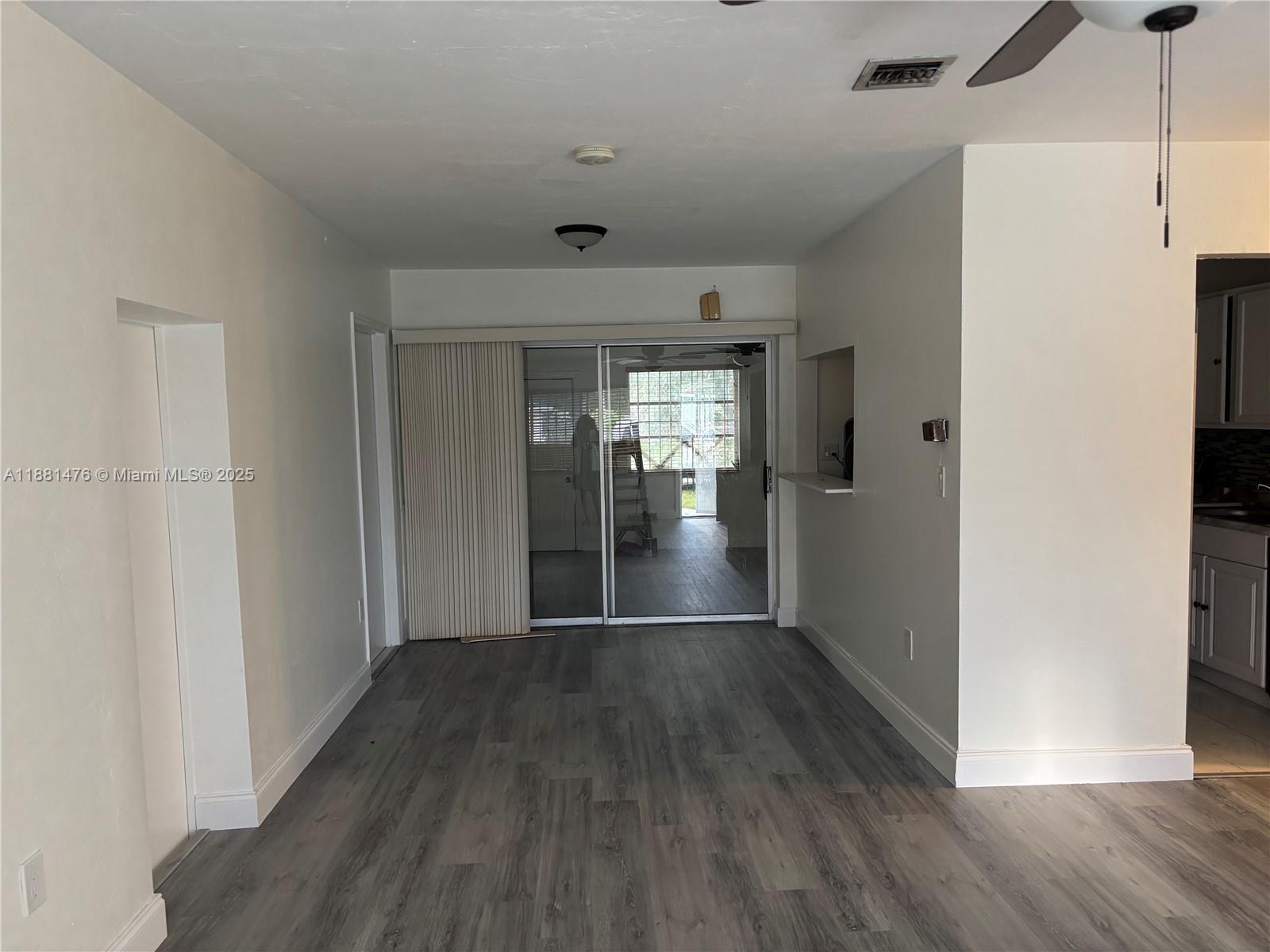 13041 Northwest 17th Court Miami, FL 33167 - Photo 7 of 23 a view of hallway with wooden floor