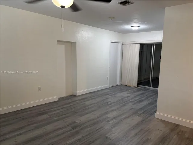 an empty room with wooden floor