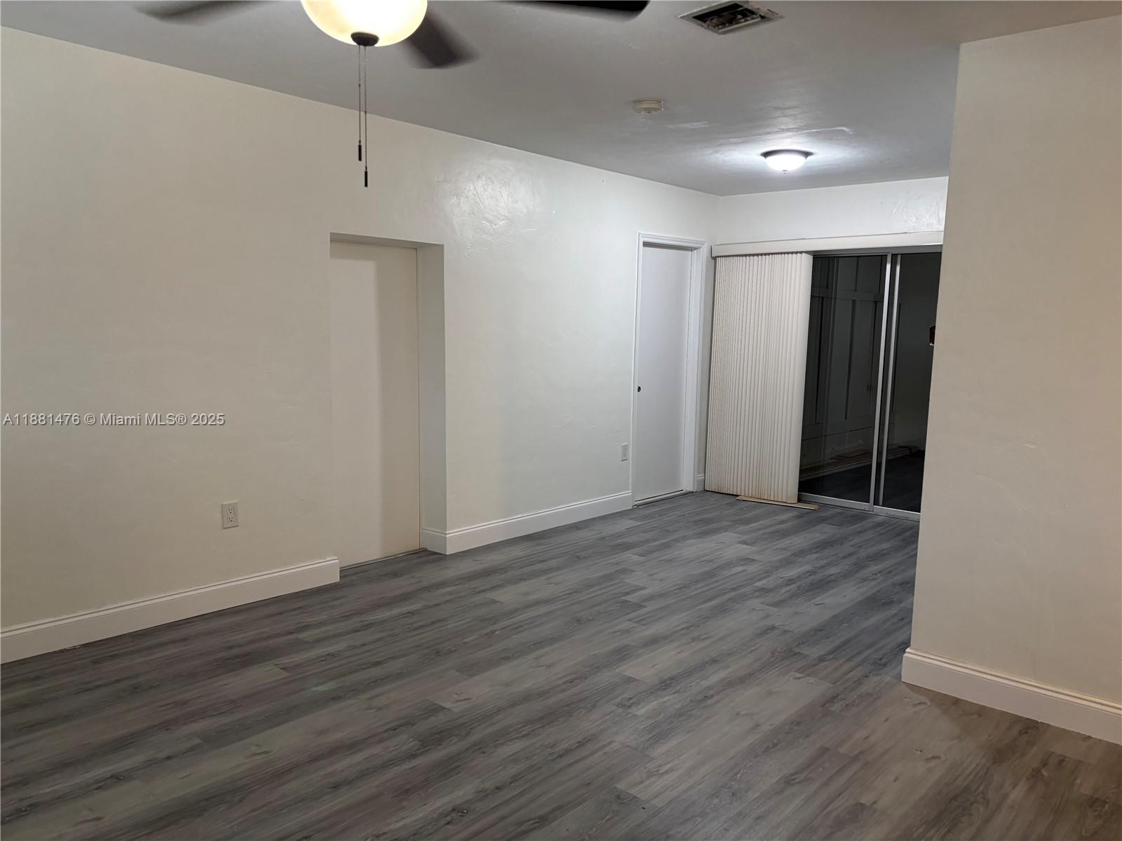 13041 Northwest 17th Court Miami, FL 33167 - Photo 8 of 23 an empty room with wooden floor