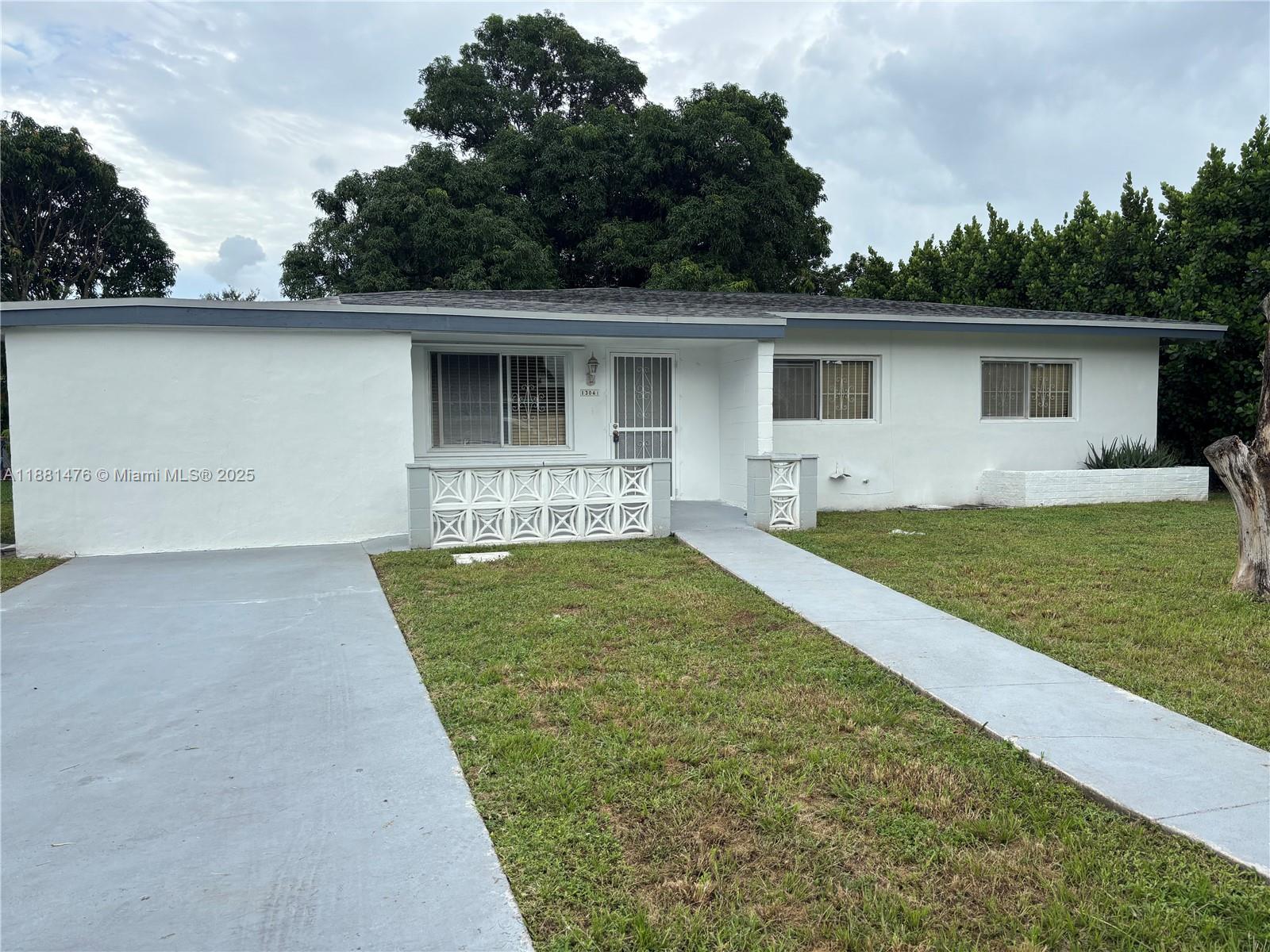 13041 Northwest 17th Court Miami, FL 33167 - Photo 9 of 23 front view of a house with a yard