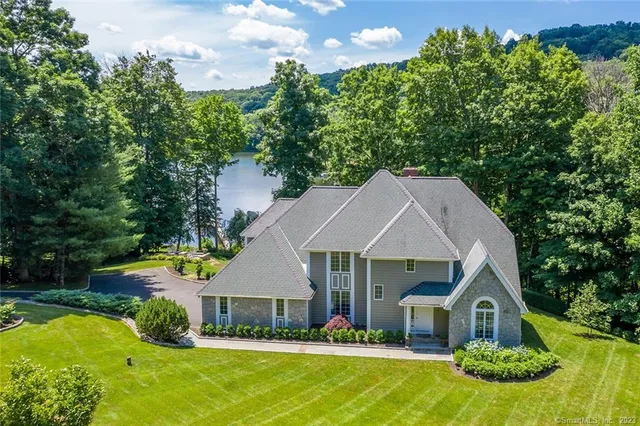 a aerial view of a house with swimming pool garden and patio