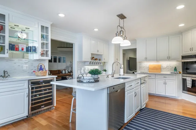 a kitchen with a sink stove and cabinets