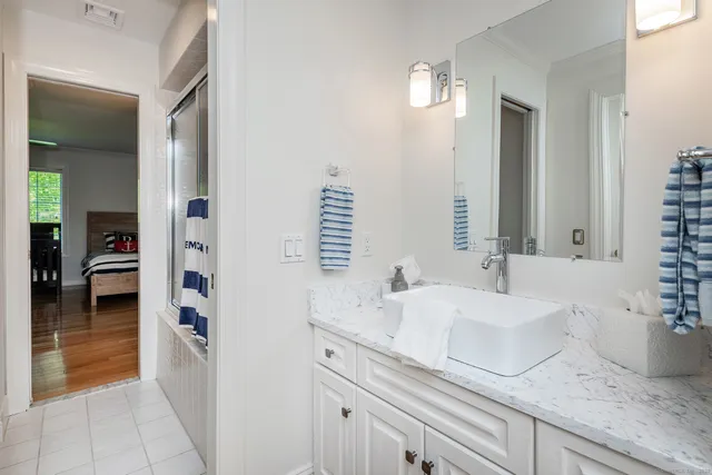 a en suite bathroom with double sink and a mirror