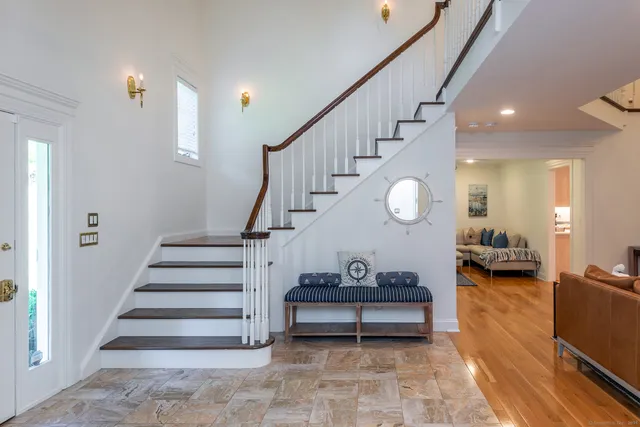 a view of entryway and hall with wooden floor