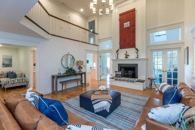 a living room with furniture kitchen view and a fireplace