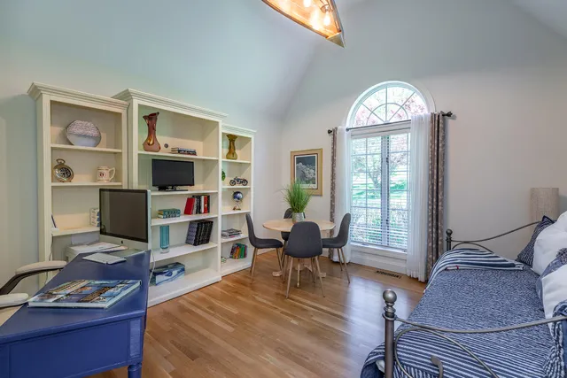 a living room with furniture cabinets and window