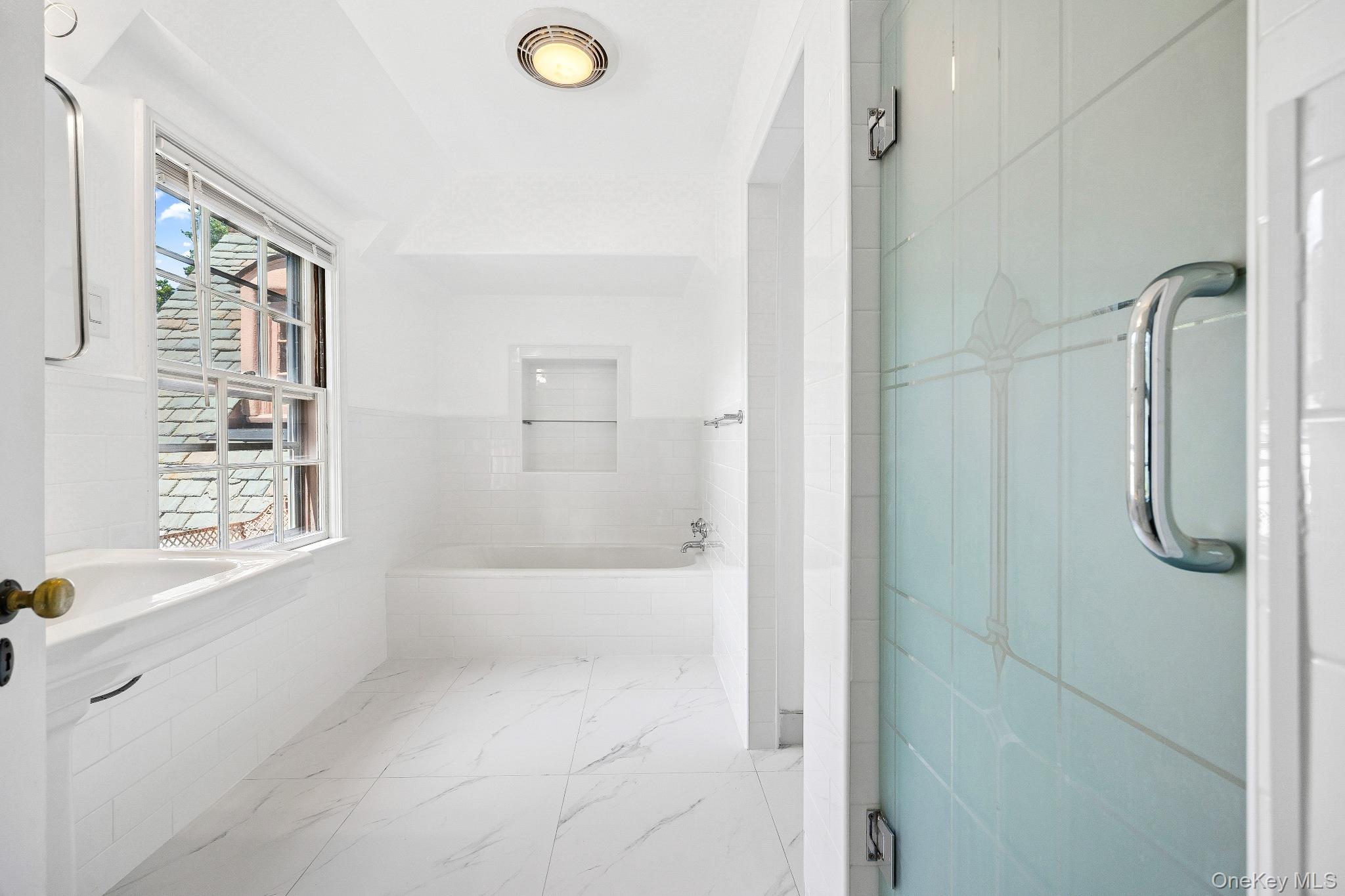 6 Fox Meadow Road Scarsdale, NY 10583 - Photo 12 of 20 Bathroom with a bath and marble finish flooring