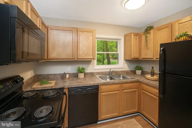 a kitchen with a sink stove and refrigerator