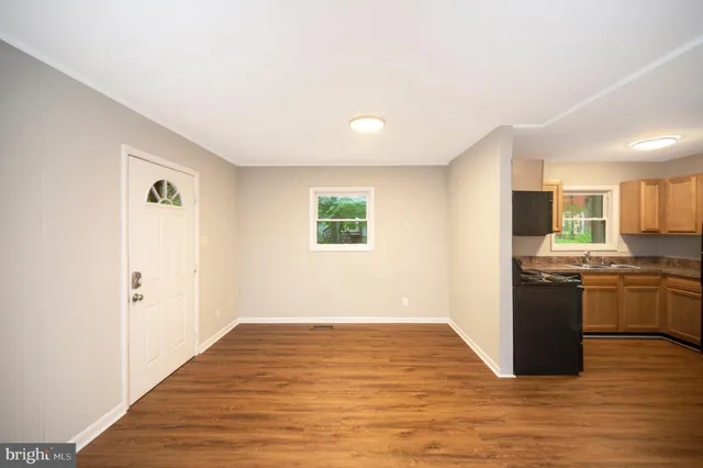 a view of a kitchen with wooden floor and electronic appliances