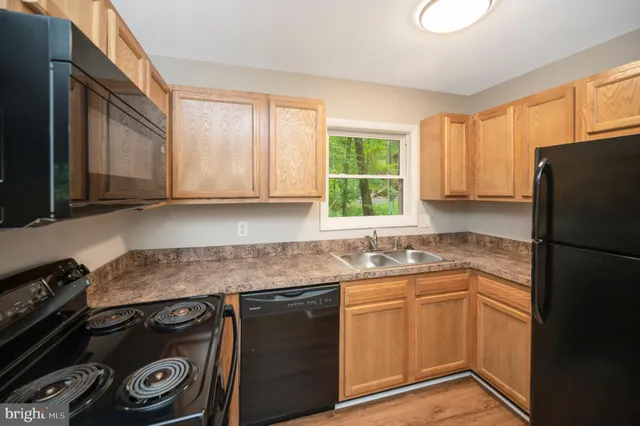 a kitchen with a sink stove and refrigerator