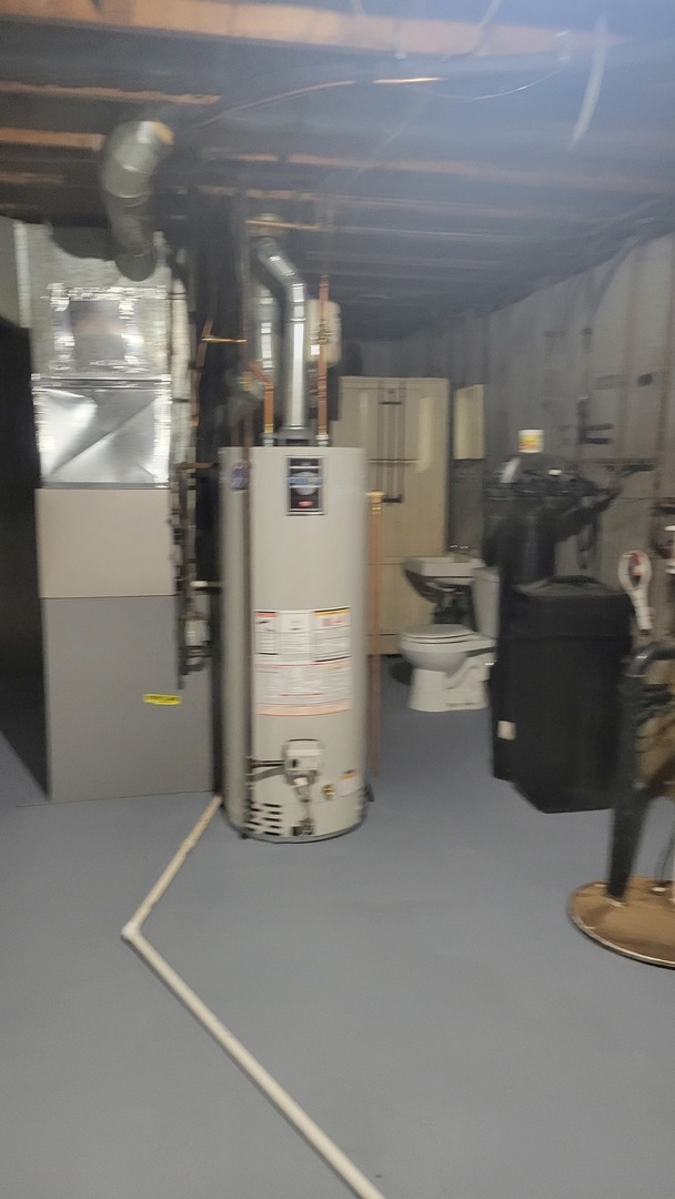 20 Highway Elgin, IL 60124 - Photo 20 of 23 a room with water heater and racks