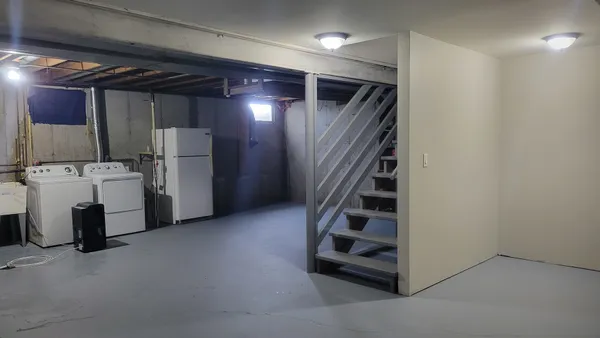 a view of storage and utility room with washer and dryer