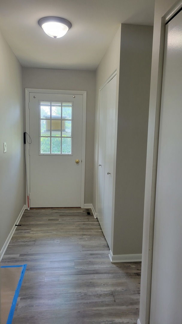 20 Highway Elgin, IL 60124 - Photo 8 of 21 an empty room with wooden floor and windows