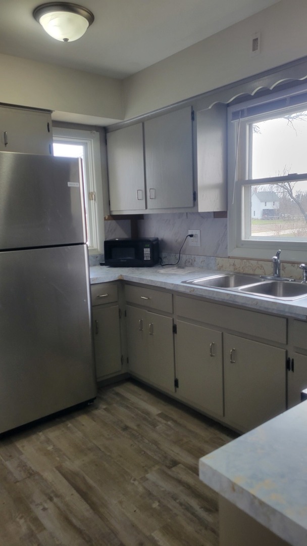 20 Highway Elgin, IL 60124 - Photo 9 of 23 a kitchen with a sink a refrigerator and window