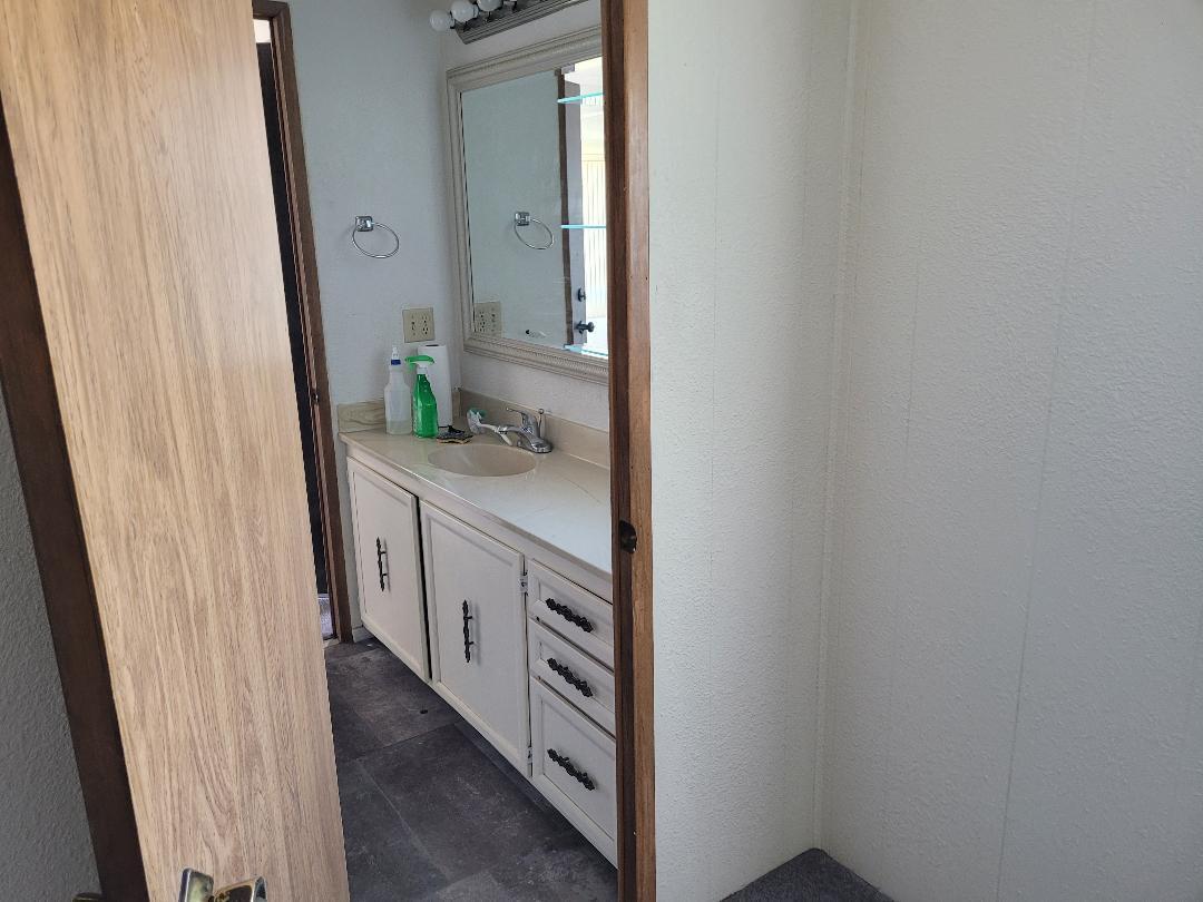 73441 Pine Valley Drive Thousand Palms, CA 92276 - Photo 5 of 12 a bathroom with a sink and a mirror