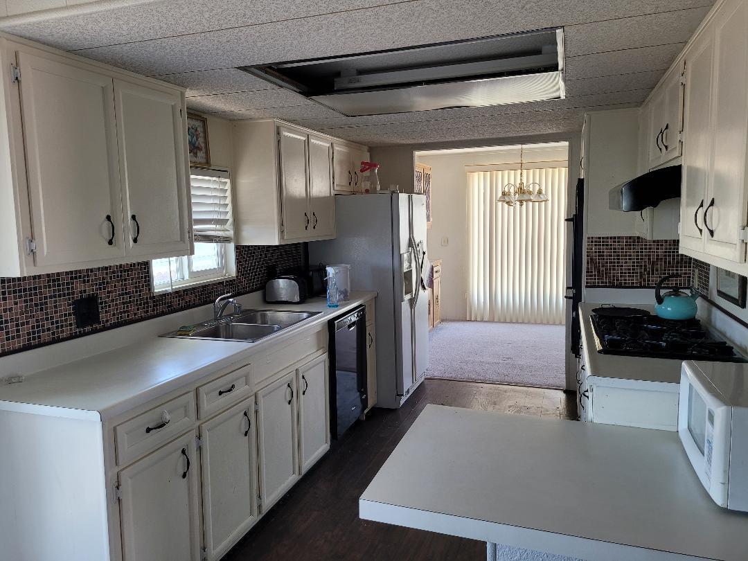 73441 Pine Valley Drive Thousand Palms, CA 92276 - Photo 7 of 12 a kitchen with stainless steel appliances a sink stove and refrigerator