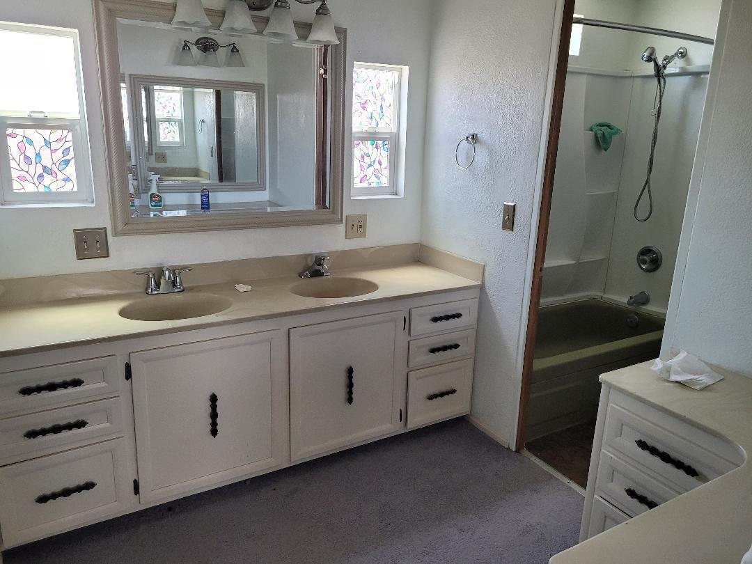 73441 Pine Valley Drive Thousand Palms, CA 92276 - Photo 9 of 12 a bathroom with a double vanity sink a mirror and a shower