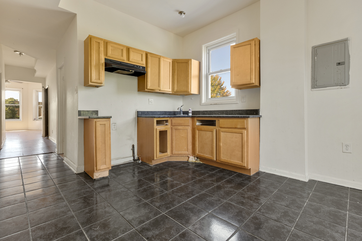 1141 South St Louis Avenue Chicago, IL 60624 - Photo 13 of 26 a kitchen with stainless steel appliances granite countertop a stove a sink and a refrigerator