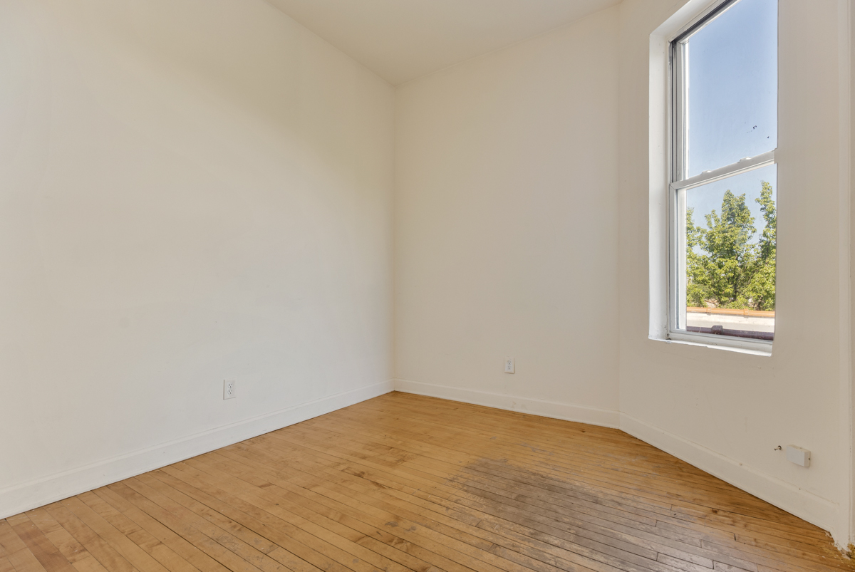 1141 South St Louis Avenue Chicago, IL 60624 - Photo 17 of 26 a view of empty room with wooden floor and fan