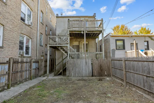 a view of a house with wooden fence